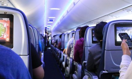 Traveler swapping seats on an airplane